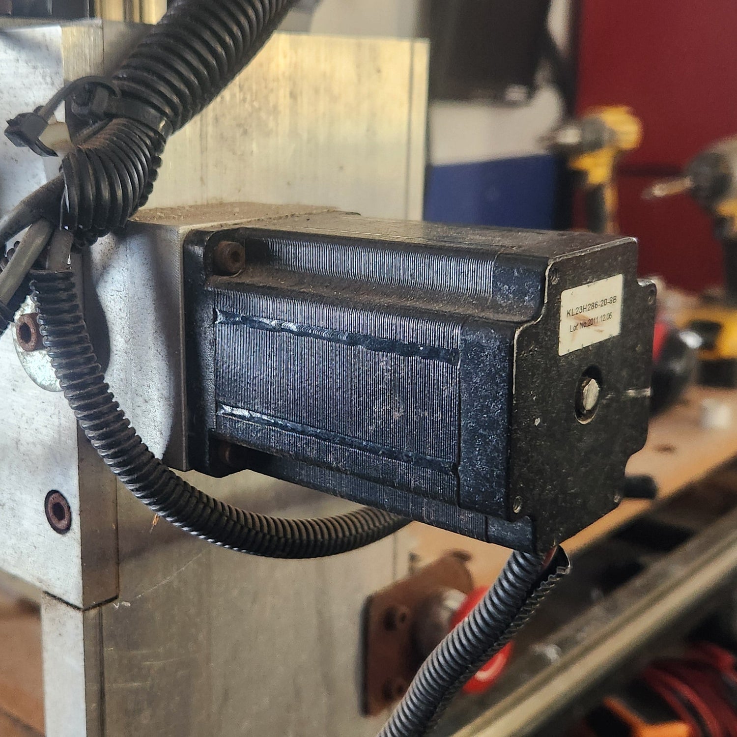 Close-up of a machine with hoses and a control panel in a workshop setting